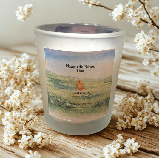 Bougie artisanale du Sud-Ouest Candèras « Plateau du Bénou » en verre givré, posée sur une surface minérale claire, avec lumière douce et fond neutre texturé.